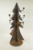 A wrought iron candlestick in the form of a Christmas tree, 24½" high