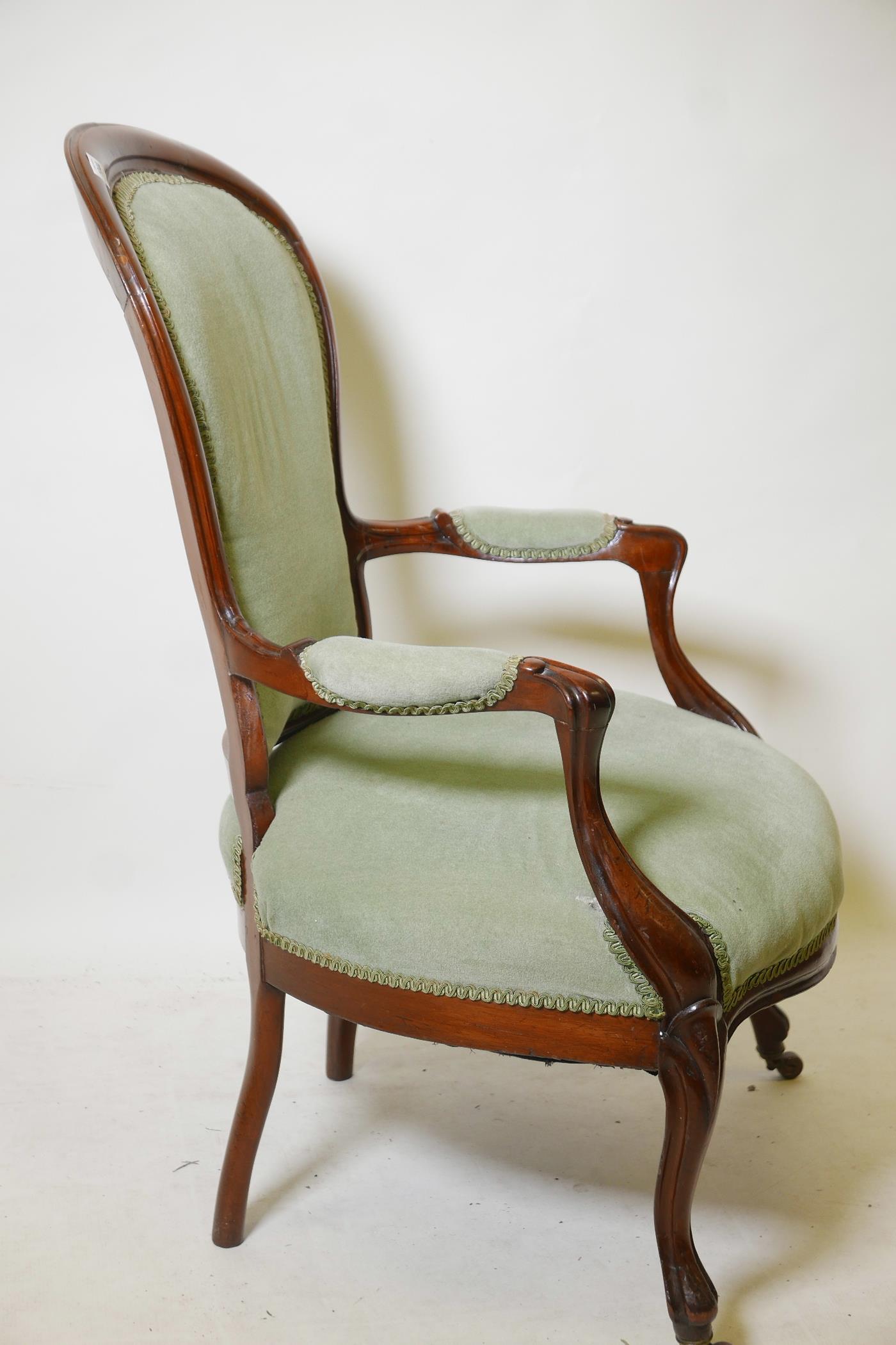 A Victorian carved mahogany spoonback open armchair with upholstered seat and back on shaped - Image 2 of 3