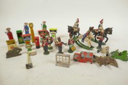 A box of small lead and die cast model soldiers, petrol pumps etc