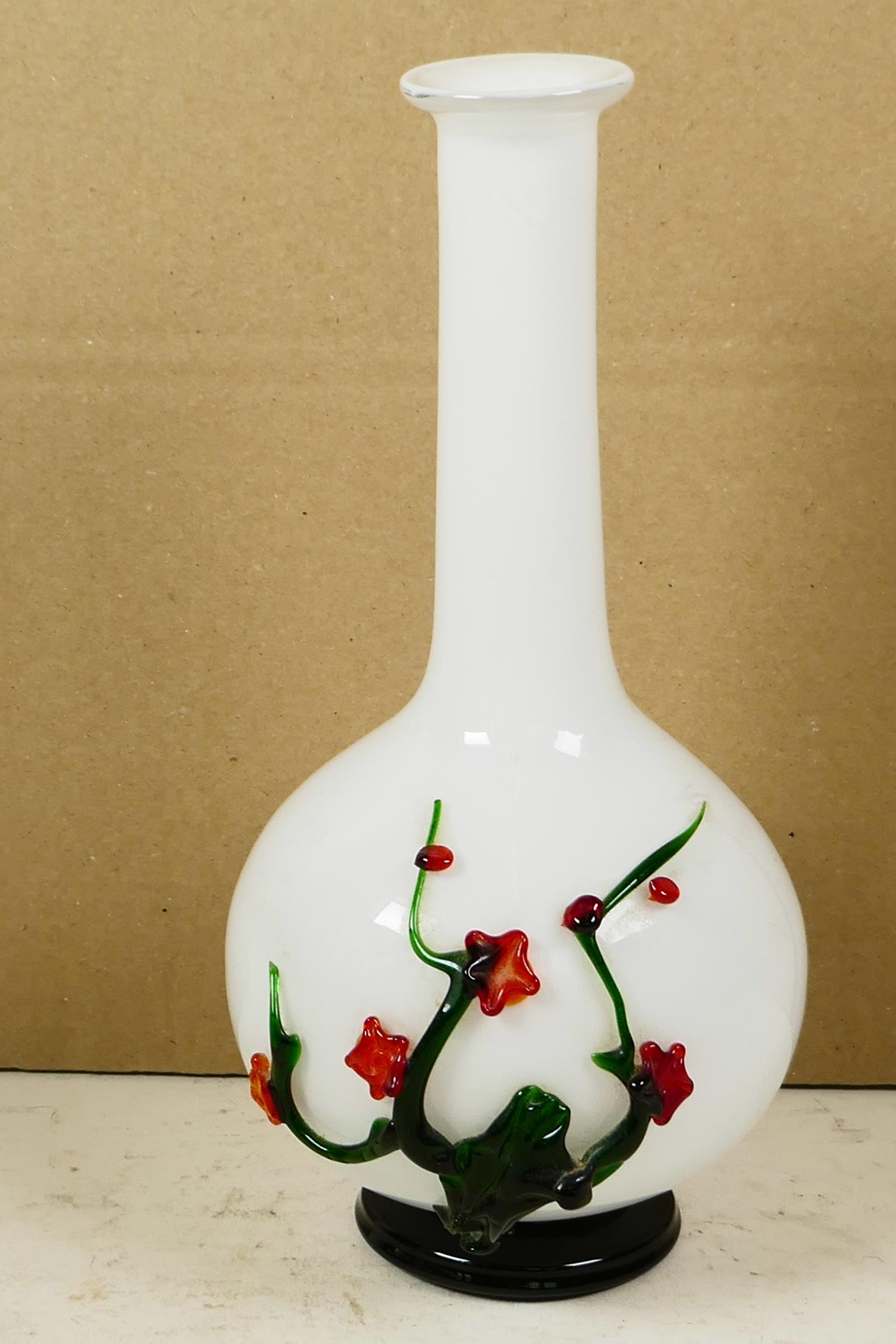 An unusual long necked white specimen vase with bulbous base, having applied decoration of a