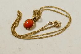 A delicate 9ct gold and coral pendant on a fine 9ct gold link chain, gross 3.4 grams