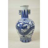 A Chinese blue and white porcelain vase with two lug handles decorated with a dragon in flight, 6