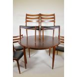 A Danish 1960s teak extending dining table and six chairs with shaped ladder back supports, 89" x