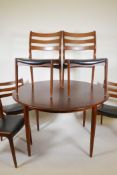 A Danish 1960s teak extending dining table and six chairs with shaped ladder back supports, 89" x