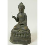 A Chinese bronze figure of Buddha seated in meditation on a lotus throne, seal mark to back, 9" high
