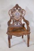 A C19th Swiss inlaid walnut musical open armchair with carved and pierced back and arms, 47½" high