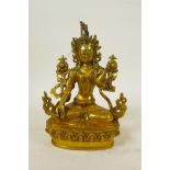 A Sino-Tibetan gilt bronze of a female deity seated on a lotus throne, double vajra mark to base, 9"