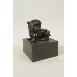 A Chinese filled bronze seal with a temple lion knop, 4" x 4", 5" high