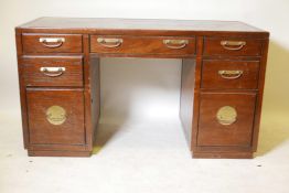 An oriental style elm seven drawer kneehole desk with brass plate handles and parquetry top, 55" x