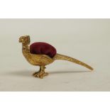 A coppered metal pincushion in the form of a pheasant, 2" long