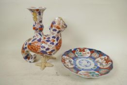 An Imari porcelain vase made in the form of a bird with vase on its back, painted in bright reds and