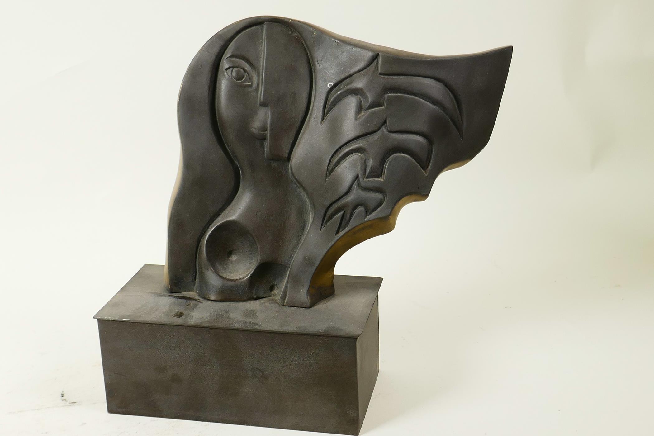 A modernist pressed bronze sculpture in the style of Picasso on a rectangular plinth, 9" high