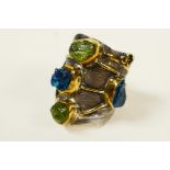 A sterling silver contemporary gemstone ring, set with rough uncut blue tourmaline and peridot,