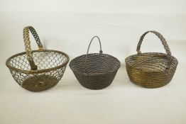 Three woven metal baskets, largest 11½" diameter