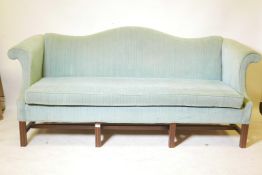 A Chippendale style hump back settee, with scroll arms raised on moulded supports, 80" wide