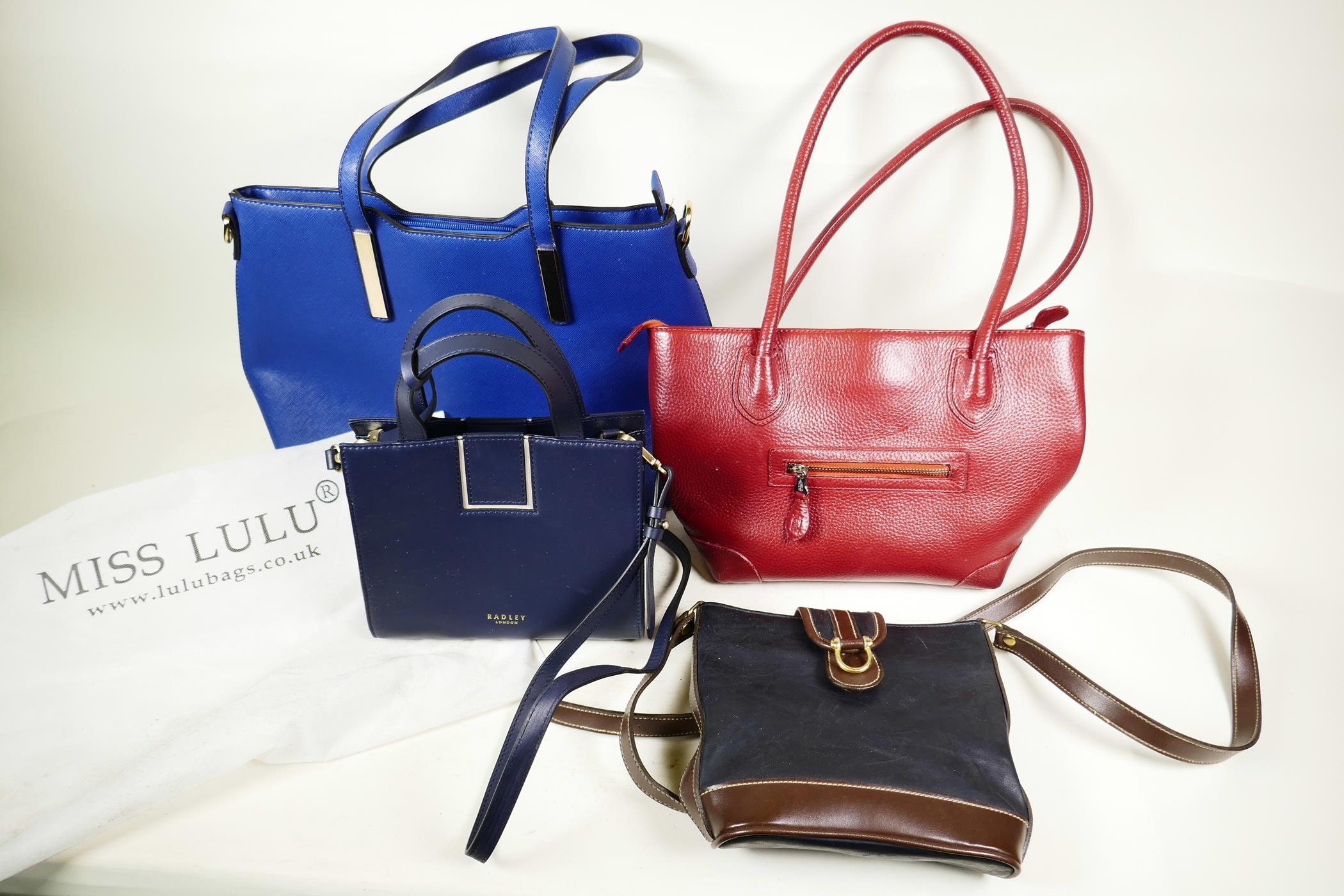 Four contemporary leather and faux leather handbags, including a new navy leather Radley small