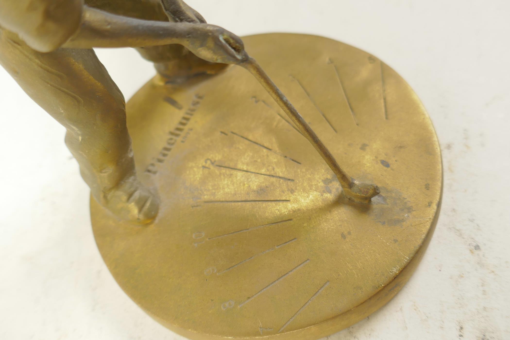 A small brass sundial cast as a young boy playing golf, 5¼" high - Image 4 of 4