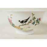 A Chinese porcelain rice bowl painted with a magpie on a flowering branch, calligraphy and seal