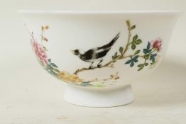 A Chinese porcelain rice bowl painted with a magpie on a flowering branch, calligraphy and seal