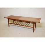 A 1970s teak shaped top coffee table with a slatted undertier, 48" x 16", 15" high
