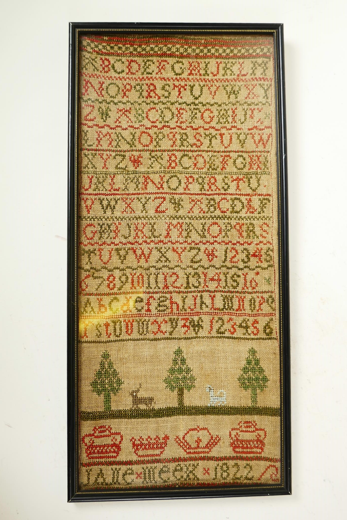 An early C19th hand stitched sampler in cross stitch by 'Jane Meek - 1822' (sister of Janet Meek),