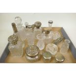 A collection of cut glass dressing table items, many with hallmarked silver lids