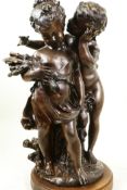 A cast bronze figure of young children, signed, 17" high