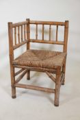 A bamboo corner chair with woven rush seat