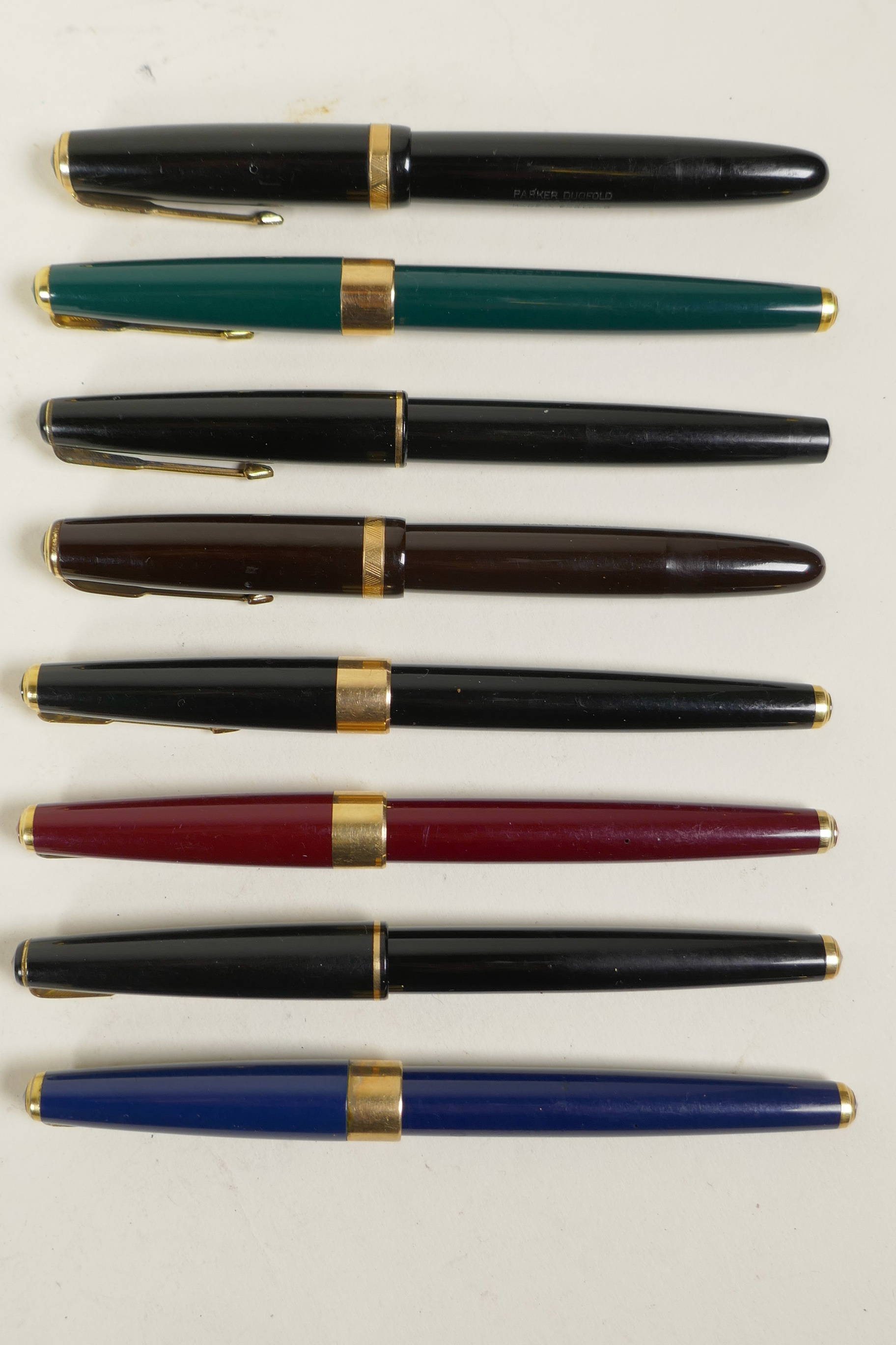 A collection of eight Parker Duofold fountain pens, all appear to have 14ct nibs, 5½" long