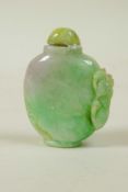 A Chinese green jade snuff bottle with carved kylin decoration, 2½" high