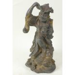 A Chinese bronze figure of a traveller with lotus leaf hat and chain of luck coins, standing with