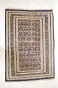 A vintage Oriental carpet with all over boteh design on a blue and cream ground, 70" x 46"