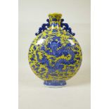 A Chinese yellow ground porcelain two handled moon flask with blue and white dragon decoration, seal