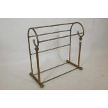 A Victorian style brass towel rail, 29" high, 29" wide, 11" deep