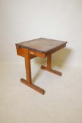 A mid-century utilitarian child's school desk