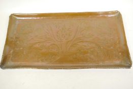 An engraved and embossed copper tray, 21" x 10½"