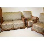 A 1930s walnut bergere suite comprising a two seat settee and two matching armchairs