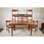 A 1960s/70s teak extending dining table and four chairs by White & Newton, extended 84" x 35", 29"
