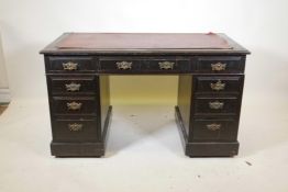 A Victorian walnut pedestal desk, with nine moulded front drawers, and brass plate handles and inset