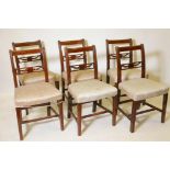 A set of six early C19th fruitwood dining chairs with carved and pierced bar backs between reeded