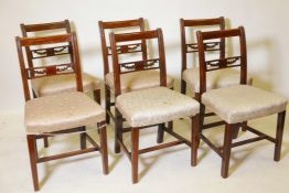 A set of six early C19th fruitwood dining chairs with carved and pierced bar backs between reeded