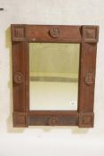 An Arts and Crafts oak wall mirror, 20" x 25"