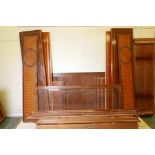 A Continental inlaid walnut armoire with marquetry inlaid panels and decorative brass mounts for