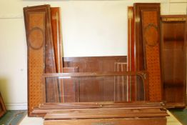 A Continental inlaid walnut armoire with marquetry inlaid panels and decorative brass mounts for