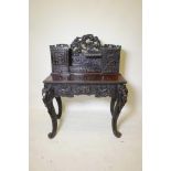 A Chinese lacquered and carved softwood desk, with lion mask carved handle and asiatic bird