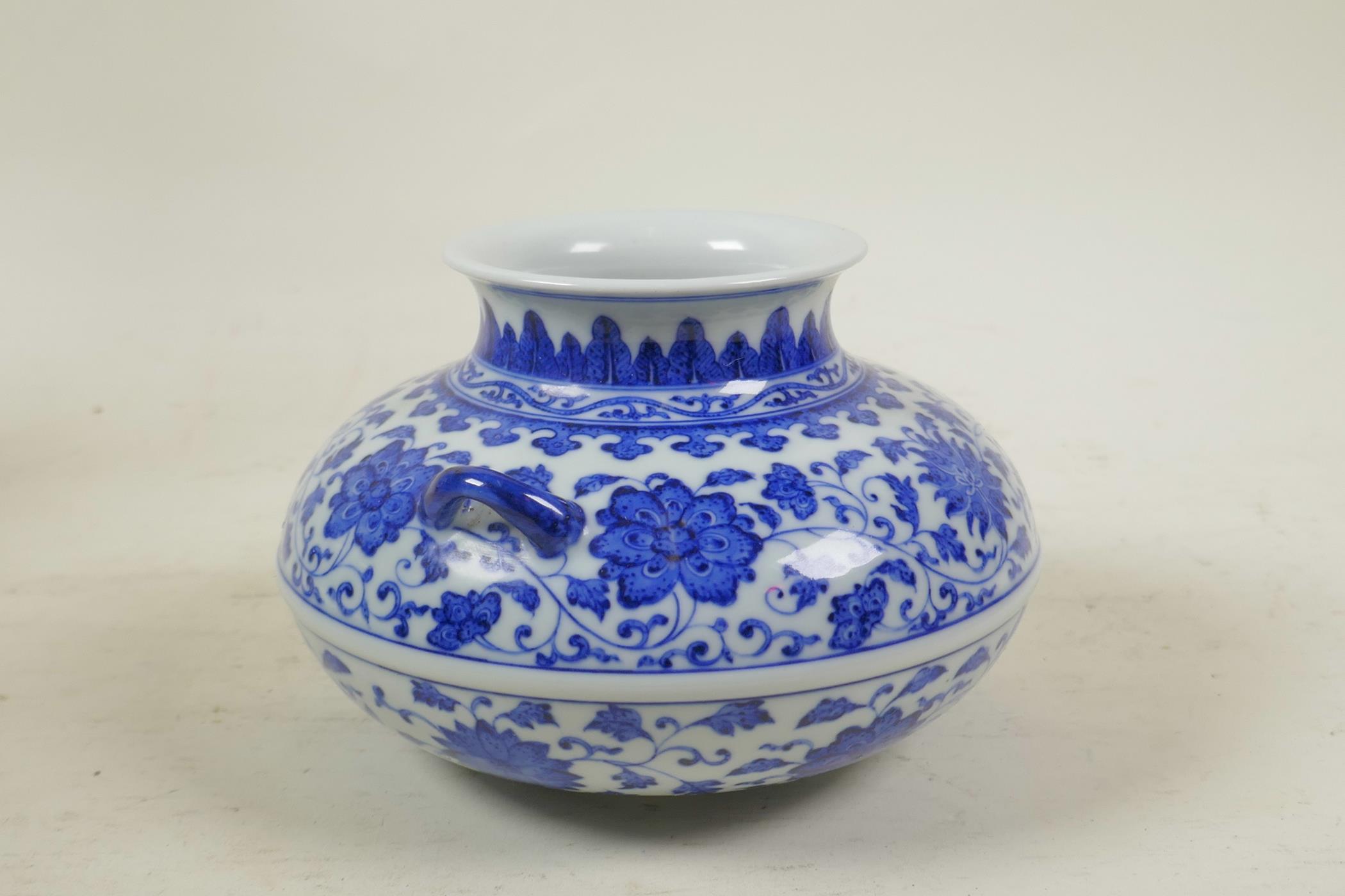 A Chinese blue and white porcelain squat form vase with two handles and scrolling lotus flower - Image 2 of 4