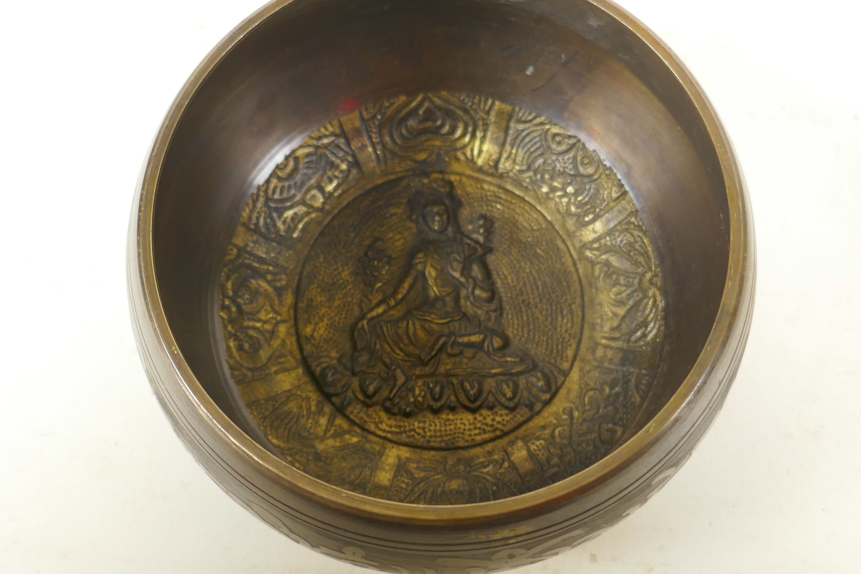 A Tibetan gilt bronze singing bowl, and another with character script decoration to exterior and - Image 7 of 7