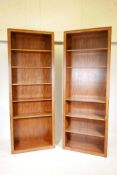 A pair of walnut open bookcases, each with one fixed shelf, the others adjustable, 32" x 12" x 87"