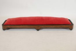 An inlaid walnut long john footstool on six ribbed feet, 44" long