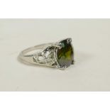 A silver dress ring set with a semi-precious green stone, approximate size 'O/P'